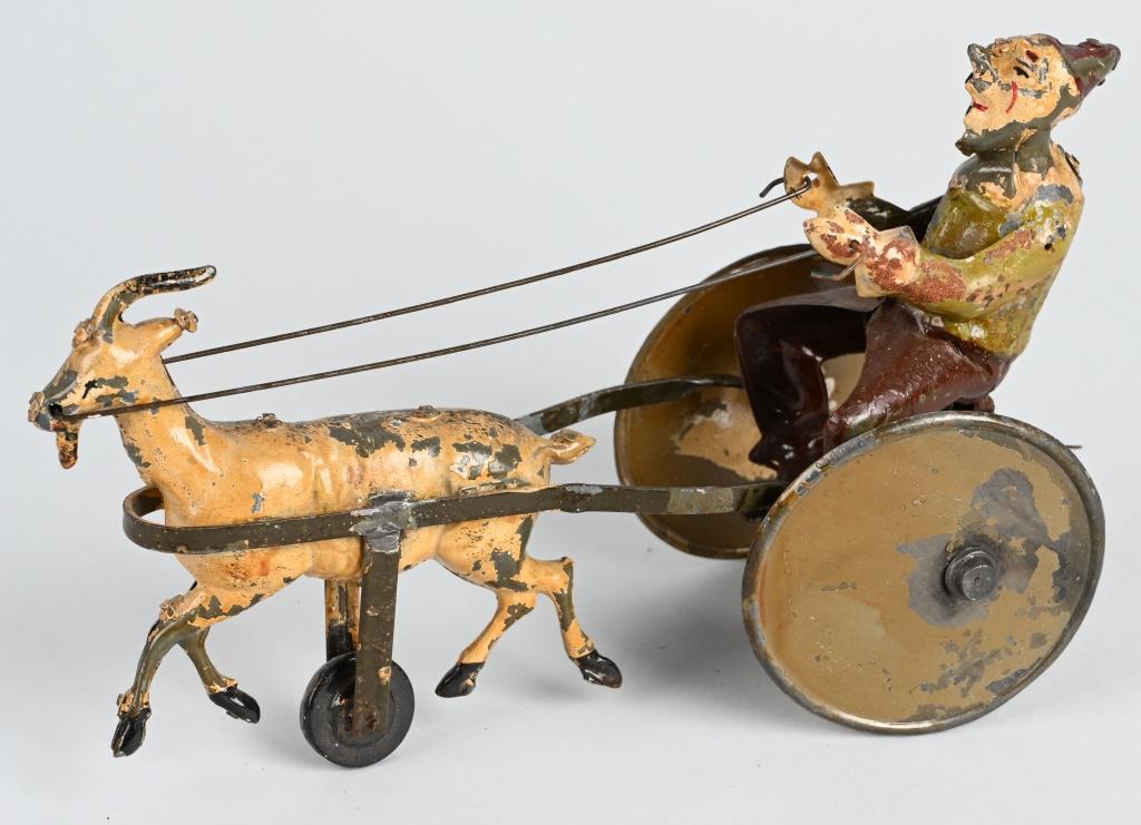 GERMAN HANDPAINTED WINDUP CLOWN IN GOAT CART: All original Clown being pulled by a Goat in Cart. Wheels have off set action. Windup works. 9" Very Good