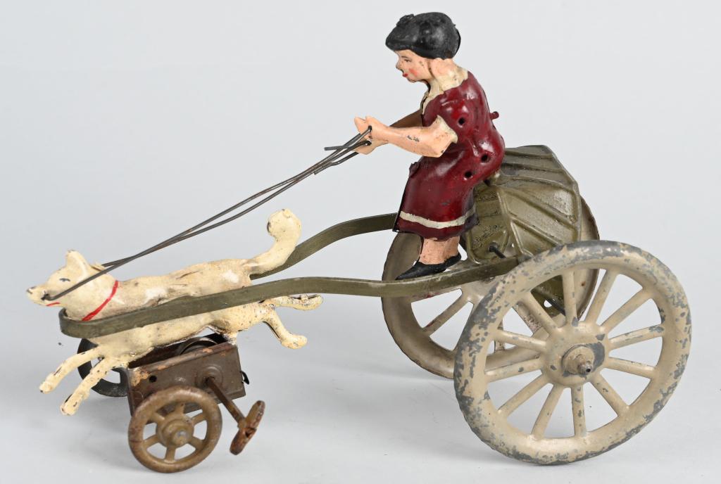 GERMAN HAND PAINTED WINDUP GIRL IN CART w/ DOG: Unusual hand painted windup Girl in Cart being pulled by a Dog. Professionally repainted. 8" Excellent