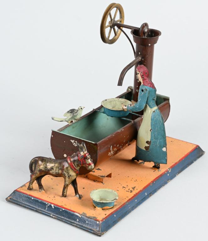 GERMAN STEAM TOY ACCESSORY LADY AT WATER TROUGH: Original steam toy accessory. Lady at water trough with bird and donkey. All original. 9" Very Good
