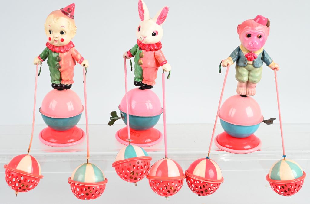 3- JAPAN WINDUP CELLULOID CIRCUS TOYS: Includes Clown on ball with bells, Rabbit Clown on ball with bells, and Monkey on ball with bells. All with great colors and working. All measure 7" Excellent