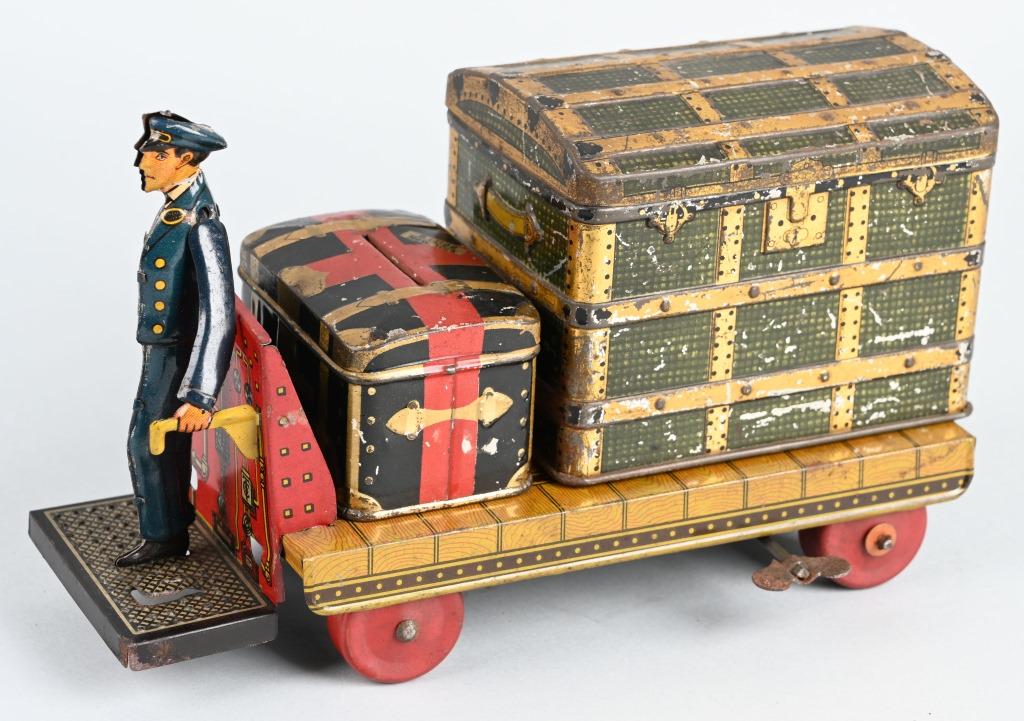 GERMAN TIN WINDUP PORTER WITH TRUNKS: Early German tin windup Porter. All original and works. Comes with 2 accessory trucks. 9" Excellent