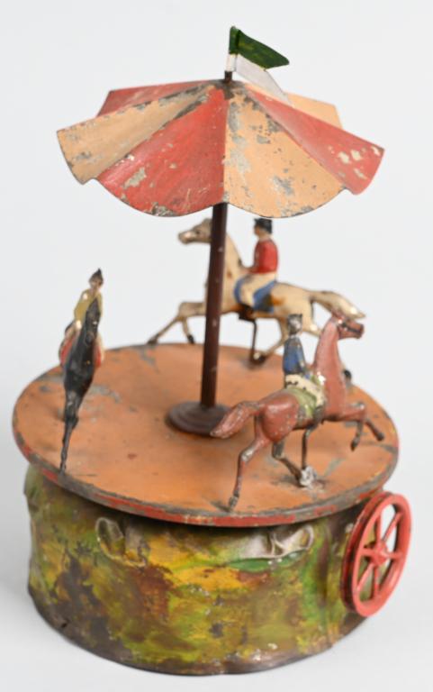 GERMAN STEAM TOY ACCESSORY MERRY-GO-ROUND: Original steam toy accessory merry-Go-Round with 3 Horse and Riders. Original condition with replaced flag. 9" Very Good