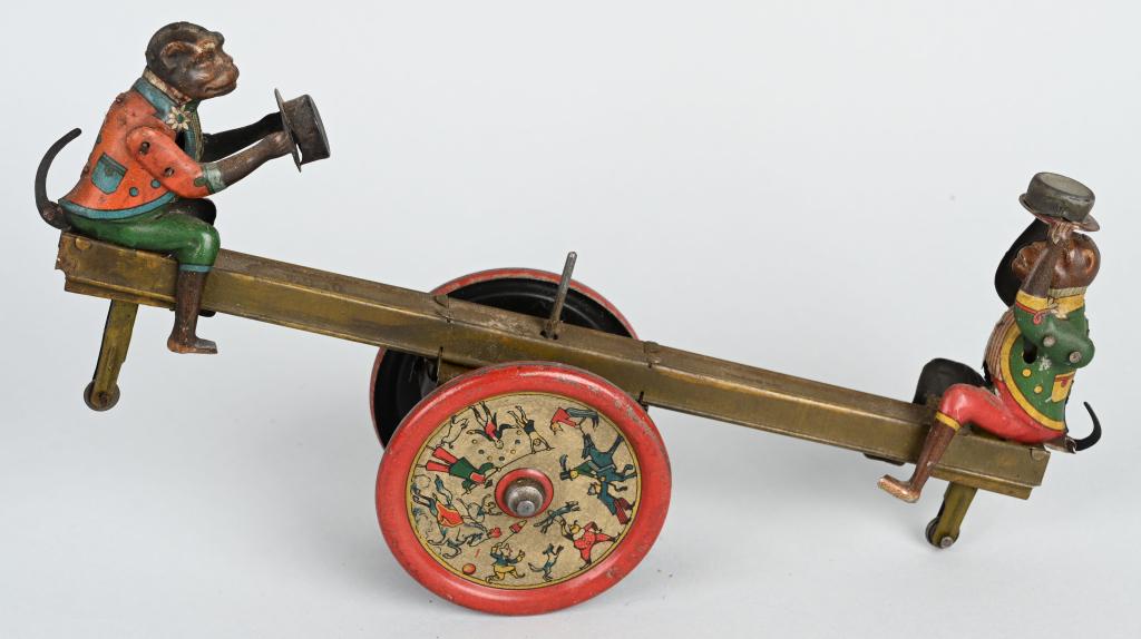 DISTLER TIN WINDUP MONKEY SEE SAW: All original and complete with 2 Monkeys. Wheels have nice graphics. Windup works. 11" Excellent