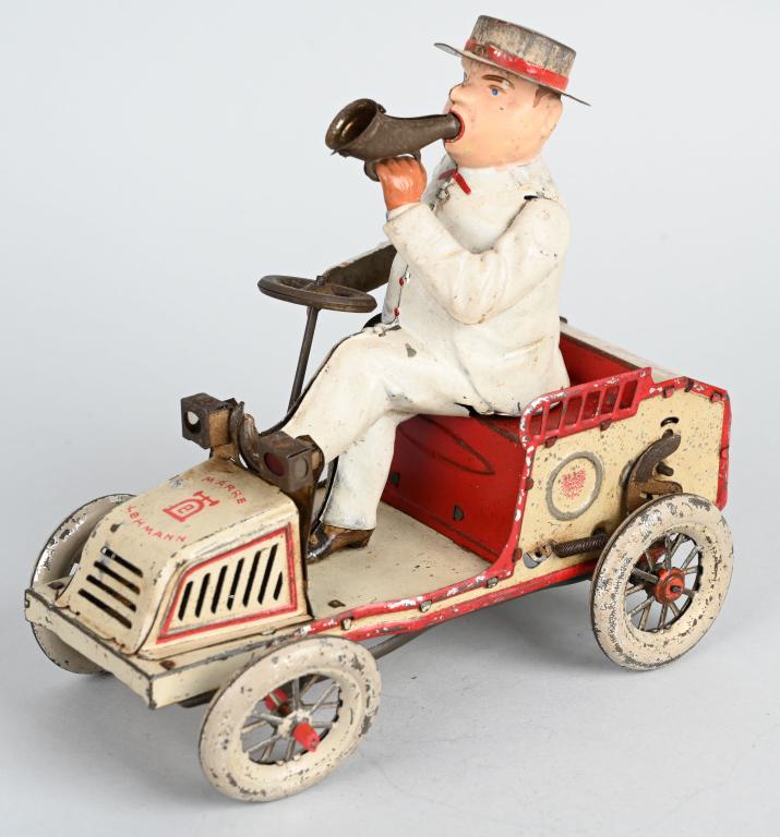 LEHMANN TIN WINDUP TUT TUT: Classic Lemann toy with portly fellow driving his car and blowing a horn. Nice complete original example. Windup works. Bellows are present but no long make sound. 7" Very Good