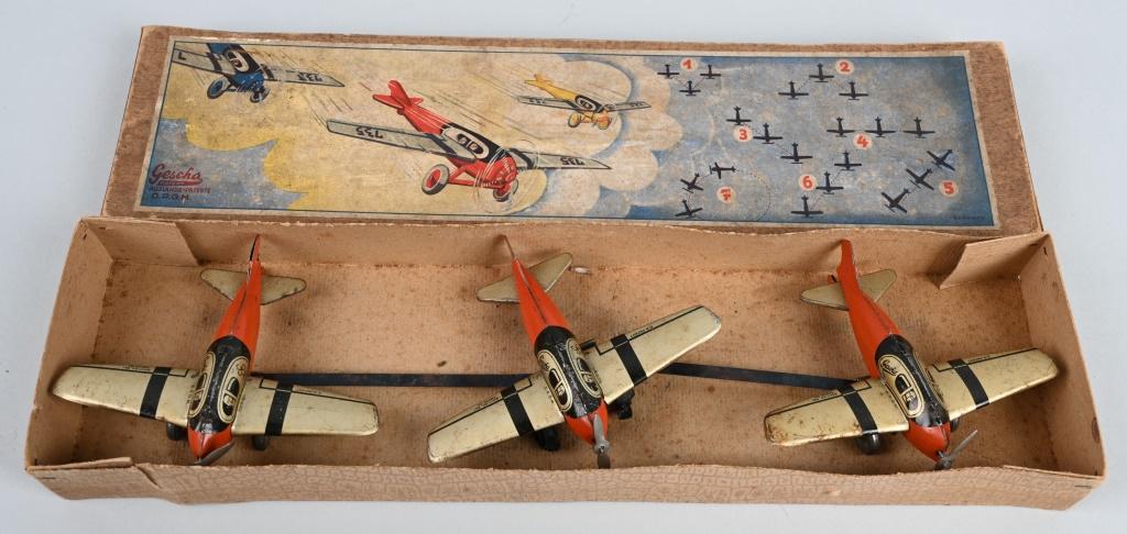 GESHA TIN WINDUP AIRPLANE SQUADRON w/ BOX: Tin windup Squadron of 3 Airplanes all attached. Windup works. Some wear to airplanes. Comes with Box. 14 1/2" Very Good