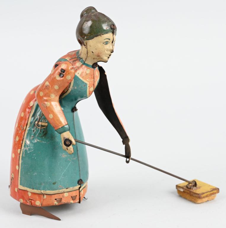 GERMAN TIN WINDUP BUSY LIZZIE: Tin windup woman with sweeper. All original and complete. Works. 7" Excellent