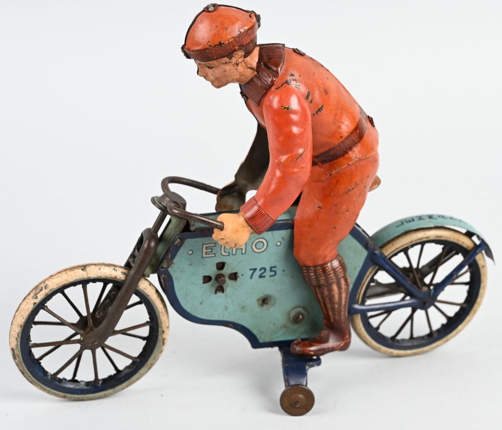 LEHAMANN TIN WINDUP ECHO MOTORCYCLE: Nice Lehmann tin windup Echo Motorcycle. Very desirable Lehmann with nice colors. Windup works. Rider has professional replacement arms. 9" Excellent