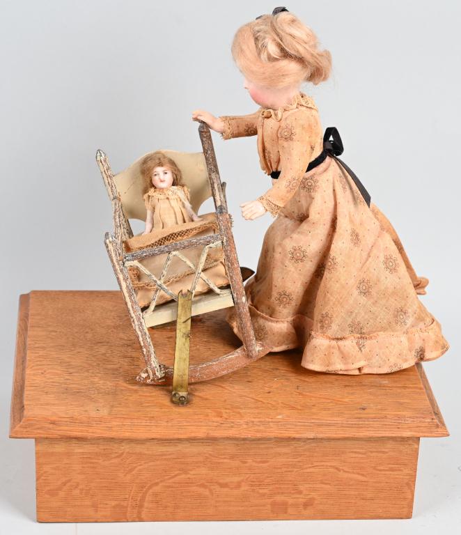 1902 ROCK A BYE DOLL AUTOMATON: Wonderful Rock A Bye Doll Automaton. Made in America in 1902 with German porcelain dolls. Mother is rocking her baby to sleep in its crib. The toy is all original and in great condition. The porcelain