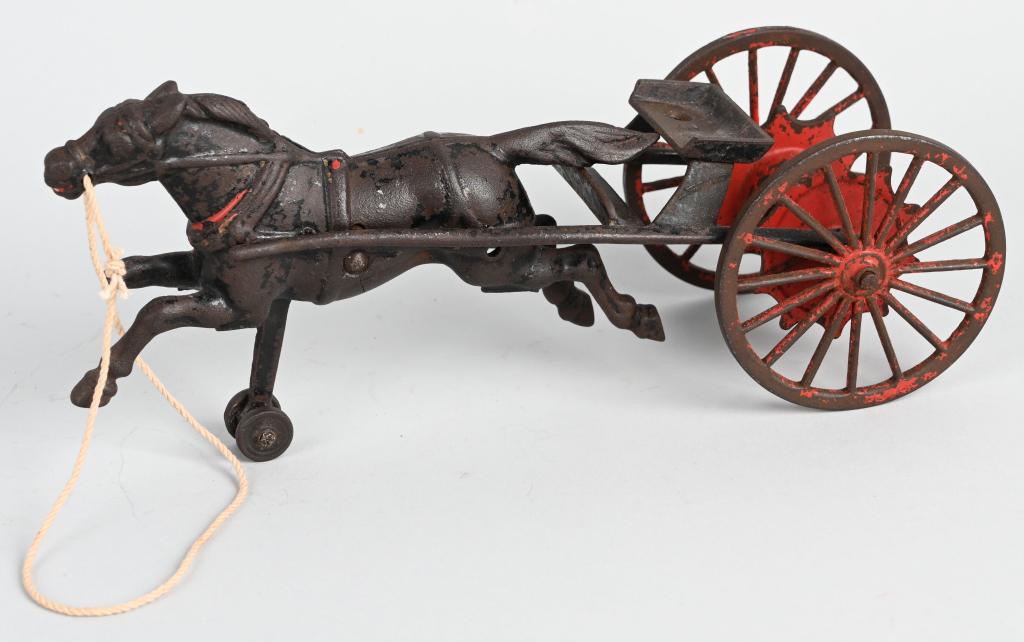 WILKINS CAST IRON HORSE DRAWN HOSE REEL: Scarce cast iron toy. All original. Horse has broken front leg and driver is missing. 10" Very Good