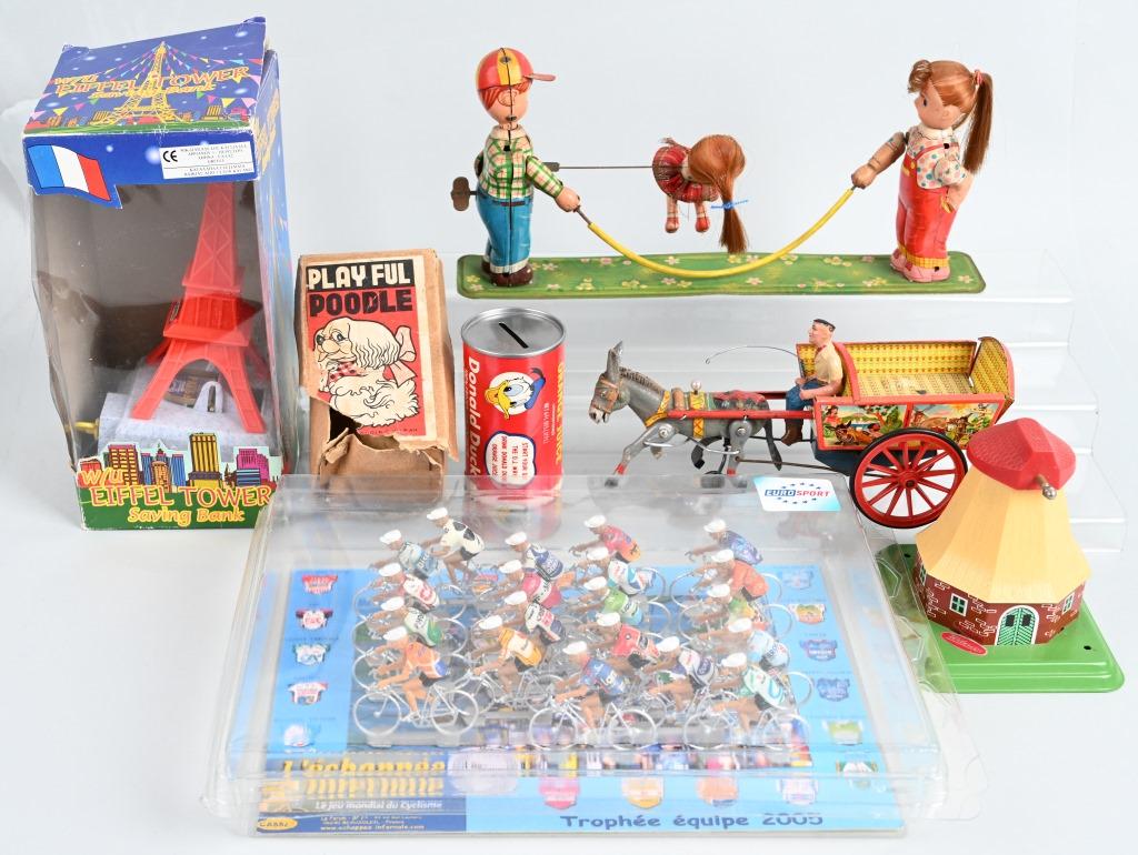 VINTAGE TOY LOT and MORE: Lot includes working German donkey cart, Wilesco steam toy, Euro Sport 2005 bicycle set, Donald Duck bank, Eiffel tower bank, windup Poodle with box, and windup Rope Skippers. Condition varies. Some d