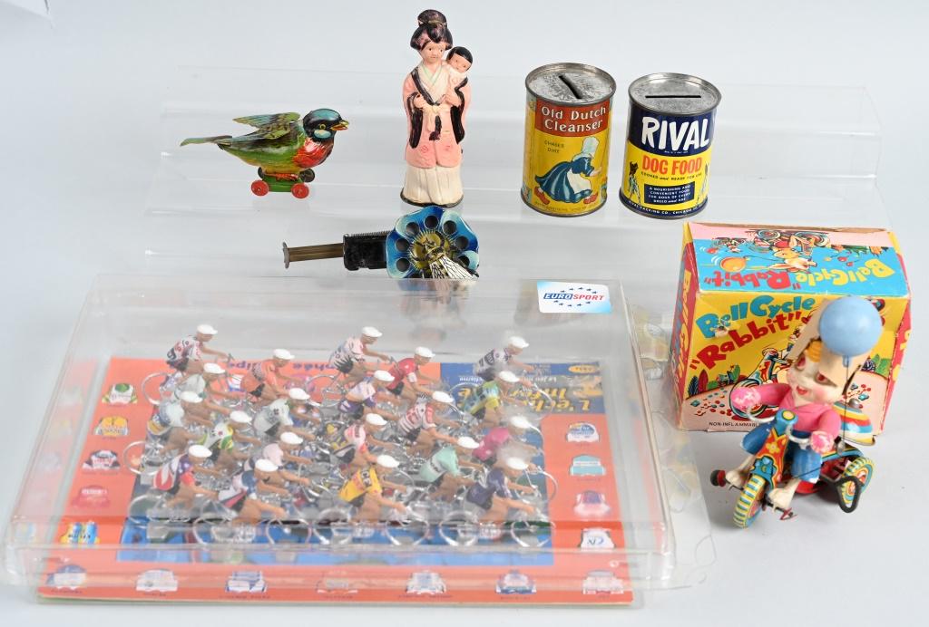 VINTAGE TOY LOT and MORE: Lot includes German Fly Sparkler. German tin Bird on wheels, Rival tin bank, Old Dutch tin bank, Japan windup Bell Cycle, Japan Celluloid windup Geisha and Euro Sport 2003 bicycle set. The windups wor
