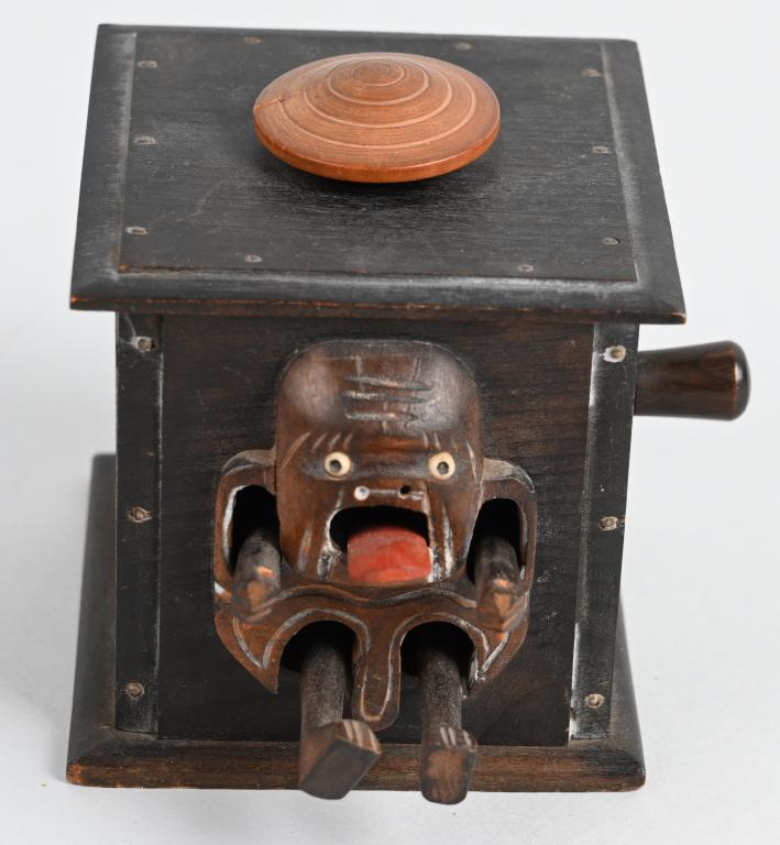 JAPAN MEIJI KOBE AUTOMATON WOOD TOY: Very nice articulated wood toy. When you turn the knob the arms, legs and tongue move, and a figure comes out of the box. Well made. Has small crack in hat. Measures about 3" by 3" by 3". Excellent