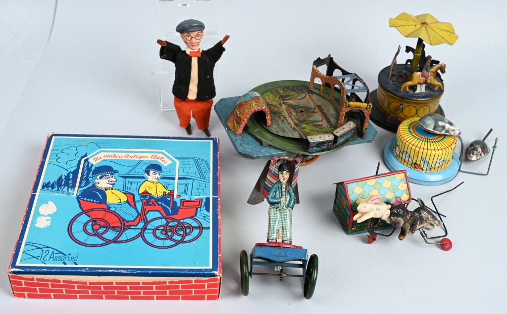 VINTAGE TOY LOT: Nice lot includes German toy parts, a Non Pareil Merry Go round, 12 assorted Miniature Antique Autos in original box, a German Harold Lloyd figure and more. Good parts or restoration . Good-Excellent