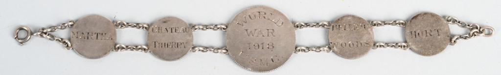 WW1 USMC BRACELET WITH BATTLE HONORS MARINE CORPS: WW1 Marine Corps bracelet made from French Silver coins. The center piece is made from a 1 Franc piece while the others are made from 50 cent pieces as seen from the reverse of the bracelet. On the ob