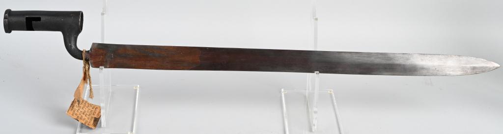 REV WAR HESSIAN BROWN BESS BAYONET FLAT BLADE: Crudely made socket bayonet with flat blade, measuring 22", with an overall length of approximately 27" and has affixed to the socket a tattered paper tag on which is typewritten "Bayonets used by Hes