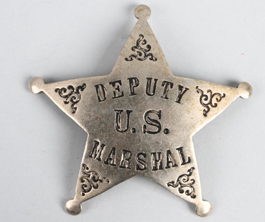 EARLY US DEPUTY MARSHAL BADGE BY LAS&SCO: Early U.S. Deputy Marshal badge measuring 2 1/2 inches with a vertical pin and catch assembly. Maker marked LAS&SCO indicating the manufacturer LOS ANGELES STAMP & STATIONERY Co. Excellent It does not