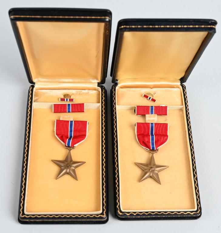 WWII US ARMY CASED SET OF BRONZE STAR MEDALS WW2: Cased pair of mint WWII US Bronze Star is cased with the original ribbon bar and rosette. The award that eventually became the Bronze Star Medal was conceived by Colonel Russell P. "Red” Reeder in 1