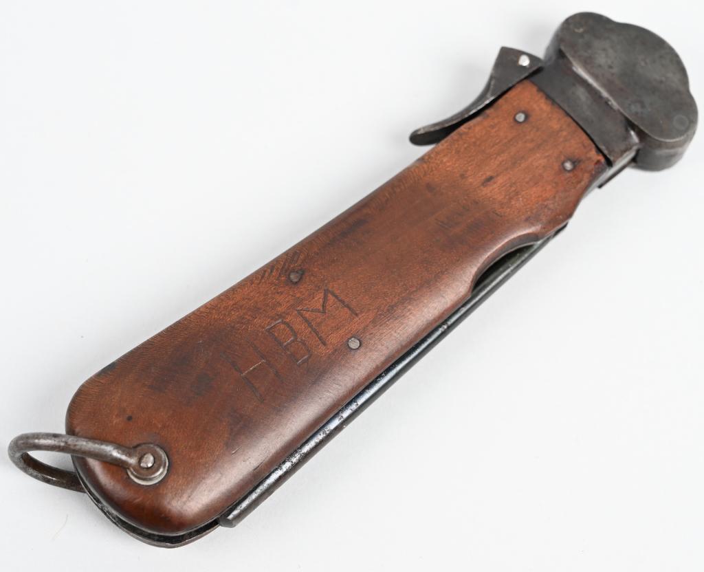 WWII NAZI GERMAN FALLSCHIRMJÄGER GRAVITY KNIFE WW2: A Luftwaffe paratrooper knife using a sliding steel blade inside a metal grip fitted with walnut, the grain running through vertically, grip plates. The blade is a relatively blunt spear-point with a 