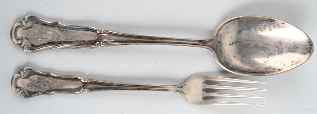 ADOLF HITLER SILVERWARE PERSONAL TABLE SERVICE: Adolf Hitler – Silverware from his Personal Table Service. Group of two pieces silverware, lunch fork and dinner spoon with overlapping engraved initials “AH”. Stamped manufacturer with silver �