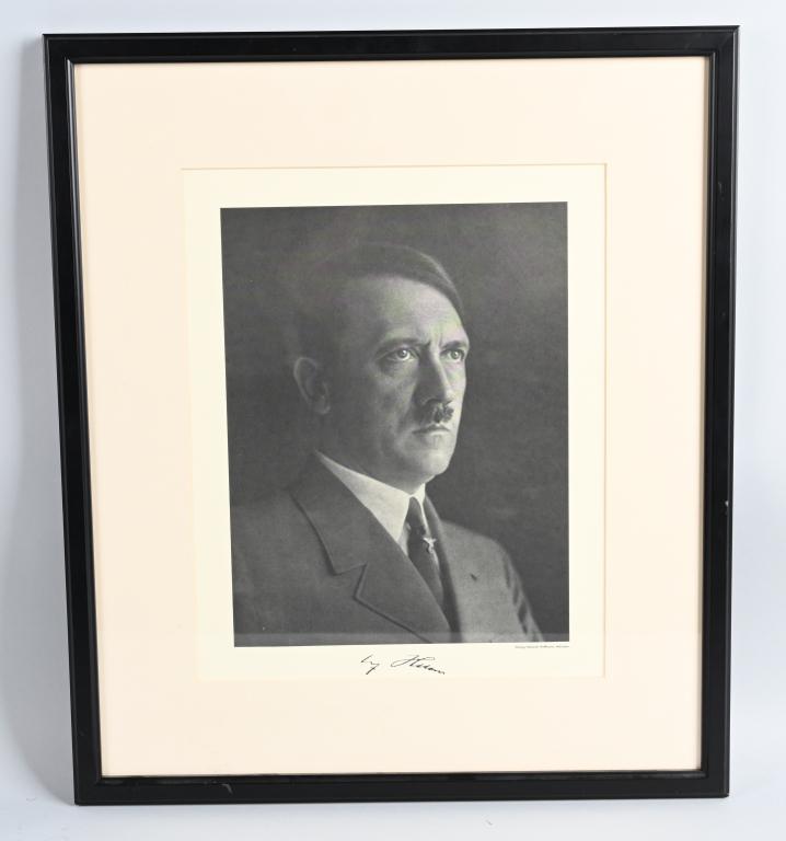 ADOLF HITLER PORTRAIT BY HEINRICH HOFFMANN FRAMED: WWII Nazi German portrait of Adolf Hitler by Heinrich Hoffmann measuring 19 X 22 in the frame. At the bottom of the photograph is a facsimile signature of Adolf Hitler. Excellent. 473 Heinrich Hoffman
