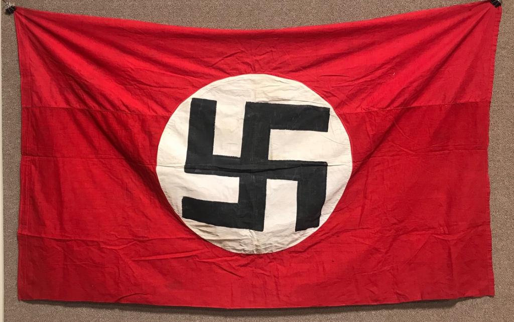 WWII NAZI GERMAN NSDAP NATIONAL WALL BANNER WW2: Multi-piece, double sided, cotton construction banner approximately 56 x 111 inches. To both its red fields are sewn white disks, with a printed mobile swastikas in black. Tunnel loop to one end. Prob