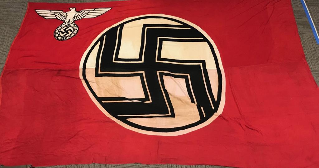 WWII NAZI GERMAN STATE SERVICE FLAG 10X16 FEET: A 1935 pattern, double sided, printed, cotton/linen construction flag. The flag features a red base field white with a white, central, circular field with a black and white bordered, black static swas
