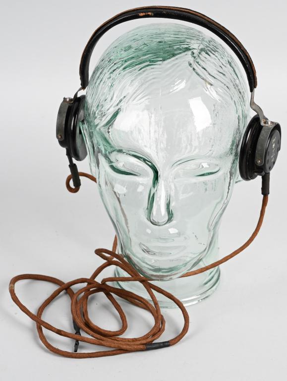 WWII NAZI GERMAN PANZER MODEL F HEADPHONE SET: The radio headset features molded, circular, black Bakelite construction earphones with black painted, metal alloy backing plates, connected by a magnetic sheet metal headband with a simulated black l