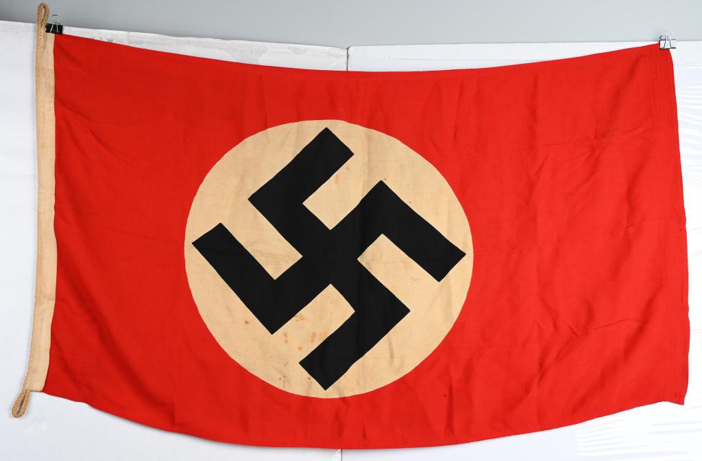 WWII NAZI GERMAN NSDAP FLAG 80X135: Printed wool construction flag measuring 80cm x 135cm. To the center are white disks, with printed mobile swastikas in black. Shows the expected period use and wear. Bunting on the hoist side are rein