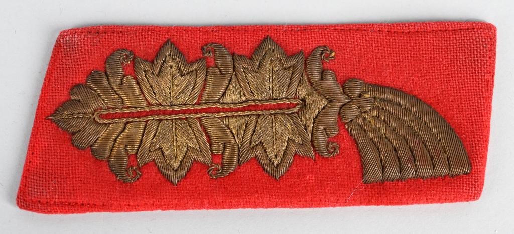 WWII NAZI GERMAN HEER GENERAL'S COLLAR TAB WW2: General’s collar tab with a red wool base and hand embroidered Arabesque style "Larisch" pattern ornamentation in gilt bullion wire threads. The Larisch pattern ornamentation consists of two, triple