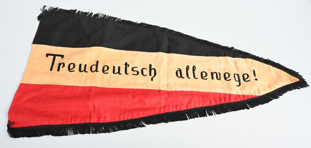 WWII NAZI GERMAN SCHOOL FLAG WITH FRINGE WW2: WWII NAZI German period pennant measuring 29 X 15 inches and has the national colors black, white and red. flag is double sided with the text to the reverse Volksschule Mehlem and on the obverse Treud