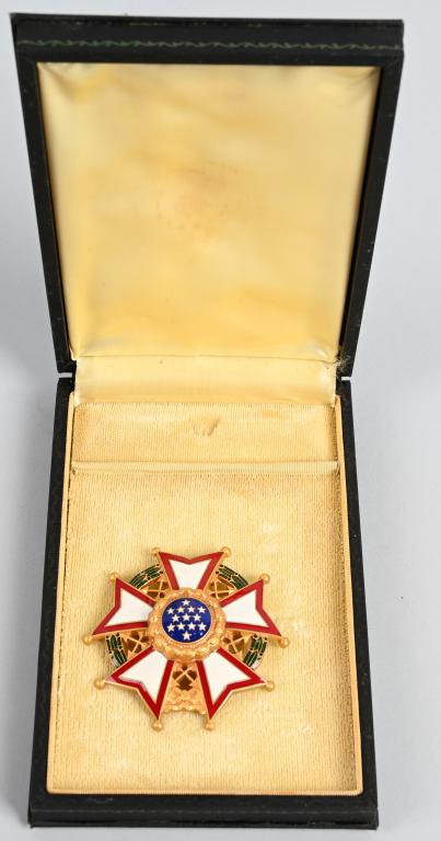 LEGION OF MERIT CHIEF COMMANDER BREAST STAR CASED: United States; Sterling silver gilt with red, white, blue and green enamels, weighing 98.56 grams, illustrating a wreath of green laurel joined at the bottom by a gold bow-knot (rosette), a domed five