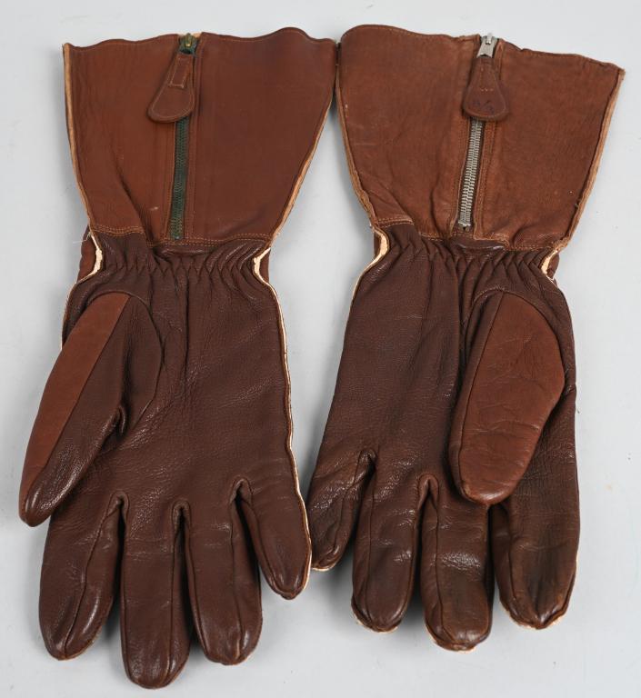 WWII 1941 RAF GAUNTLET LEATHER FLYING GLOVES NAMED: A beautiful pair of supple brown leather Air Ministry issued Flying Gauntlets as used by the RAF during the Battle of Britain. These pair were in fact issued in 1941 and bear the Crown and AM stamp al