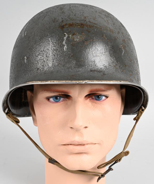 WWII US NAVY M1 FIXED BAIL COMBAT HELMET W/ LINER: WWII US Navy fixed bail M1 combat helmet with Westinghouse liner. Helmet retains most of it's original battleship gray over paint. The helmet for some unknown reason on the forward edge of the shell h