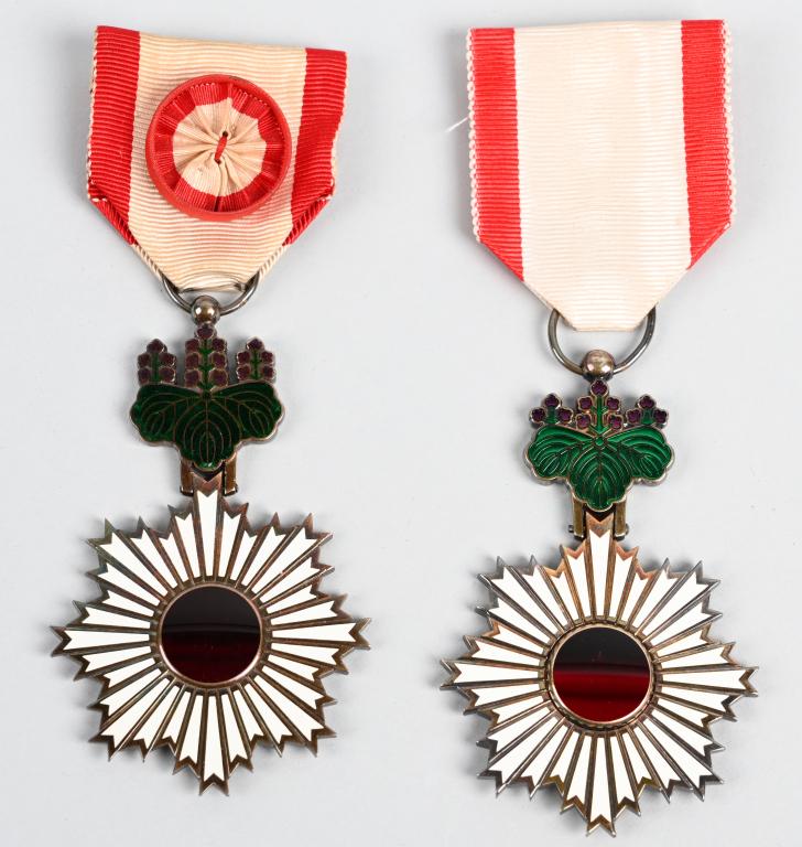 2 WWII JAPANESE ORDER OF THE RISING SUN MEDALS WW2: Two Imperial Japanese military decorations known as the Order of the Rising Sun. Includes the 4th Class, with gold rays and a red and white rosette attached to the ribbon drape, and the 5th Class, wit