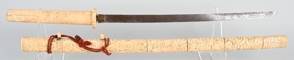 CARVED BONE KATANA SAMURAI SWORD: This modern Katana sword has a really decorative carved handle (Tsuka) and sheath (Saya). Made from bone, and intricately carved with oriental scenes with an overall size of 35 1/2 inches.