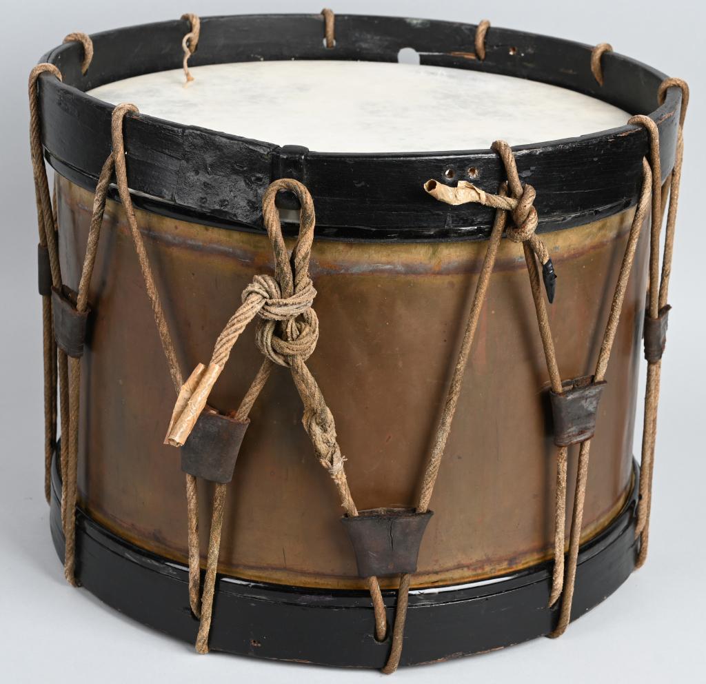 WWII ERA BRASS SNARE DRUM POSSIBLY BRITISH MADE: 1940's Era brass snare drum measuring 16 X 12 1/2 inches with modern heads but original rope and tension devices. There is no manufacturing marks but to me appears British made. Overall in very good c