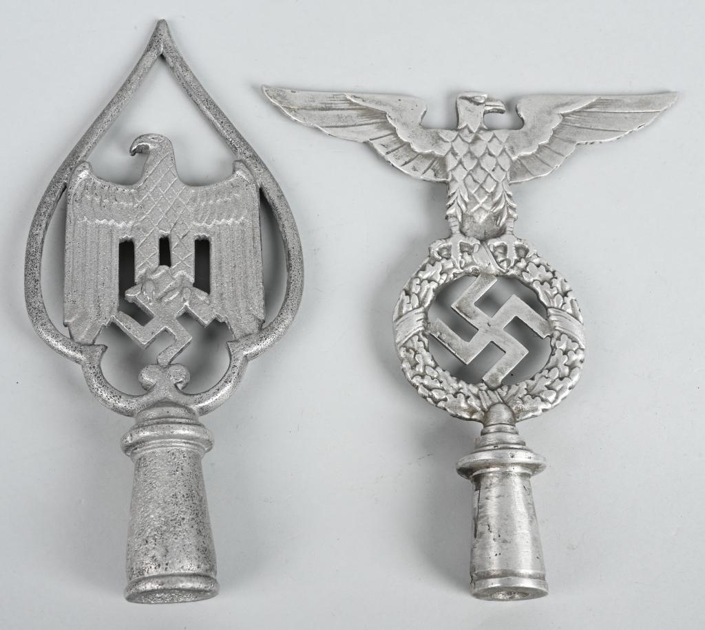 WWII NAZI GERMAN REPRO POLE TOPS ARMY NSDAP: Two WWII Nazi German REPRODUCTION pole tops including 1) NSDAP POLITICAL FLAG POLE FINIAL. An aluminum flag pole finial, in the form of an eagle whose outstretched wings have a span of 7 1/2 inches an