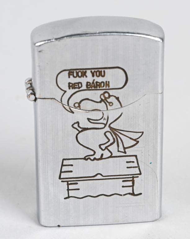 VIETNAM SNOOPY FUCK YOU RED BARON LIGHTER: Iconic Snoopy cigarette lighter manufactured by Zenith and is marked to the bottom of the lighter. To the obverse is Snoopy on top of his Dog House wearing his iconic flight helmet, goggles and scarf,