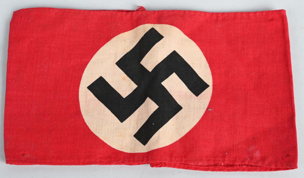 WWII NAZI GERMAN NSDAP PRINTED ARMBAND WW2: Late WWII red cotton armband, with an approximately 9cm diameter printed white disk, with a black mobile swastika. Excellent Probably one of the most recognizable pieces of insignia associated with th