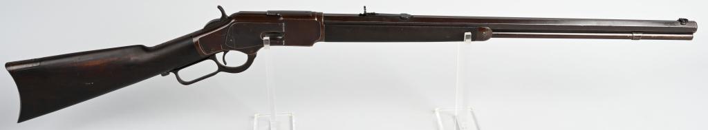 WINCHESTER MODEL 1873 LEVER ACTION RIFLE: SERIAL 304050. BARREL 24". CALIBER .32 WCF. MADE IN 1889. Standard full octagon rifle, full magazine, semi buckhorn rear sight, folding beach front sight, blue finish, walnut stock with crescent butt.
