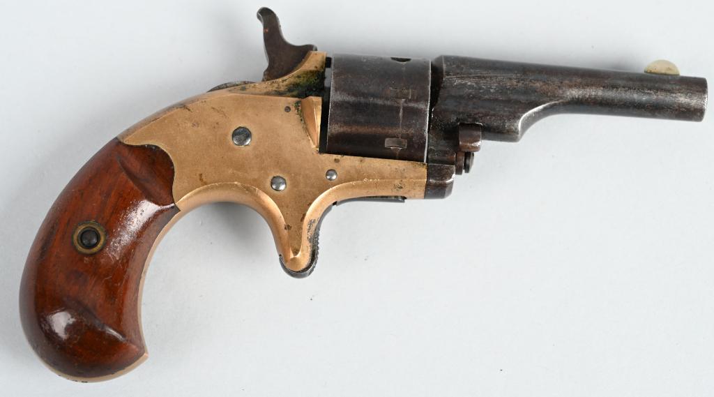 COLT OPEN TOP POCKET MODEL REVOLVER: SERIAL 29715. BARREL 2 1/4". CALIBER .22 SHORT RIMFIRE. MADE IN 1874. Matching numbers. Features brass frame, 7-shot, single action, spur trigger, walnut birds head grips, blue barrel & cylinder. Barr