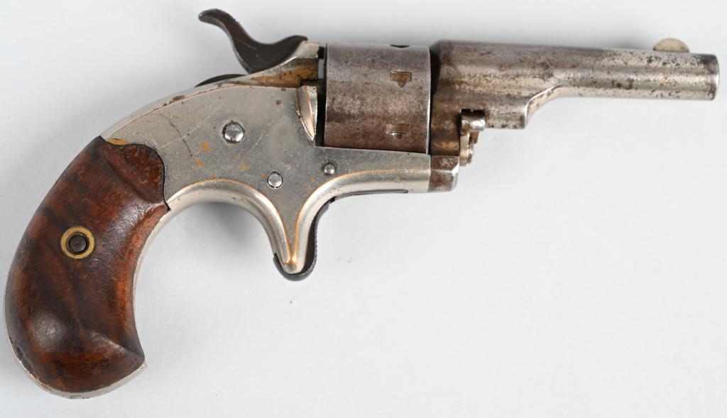 COLT OPEN TOP POCKET MODEL REVOLVER: SERIAL 63145. BARREL 2 1/4". CALIBER .22 SHORT RIMFIRE. MADE IN 1875. Matching numbers. Features brass frame that is nickel plated, 7-shot, single action, spur trigger, walnut birds head grips, nickel