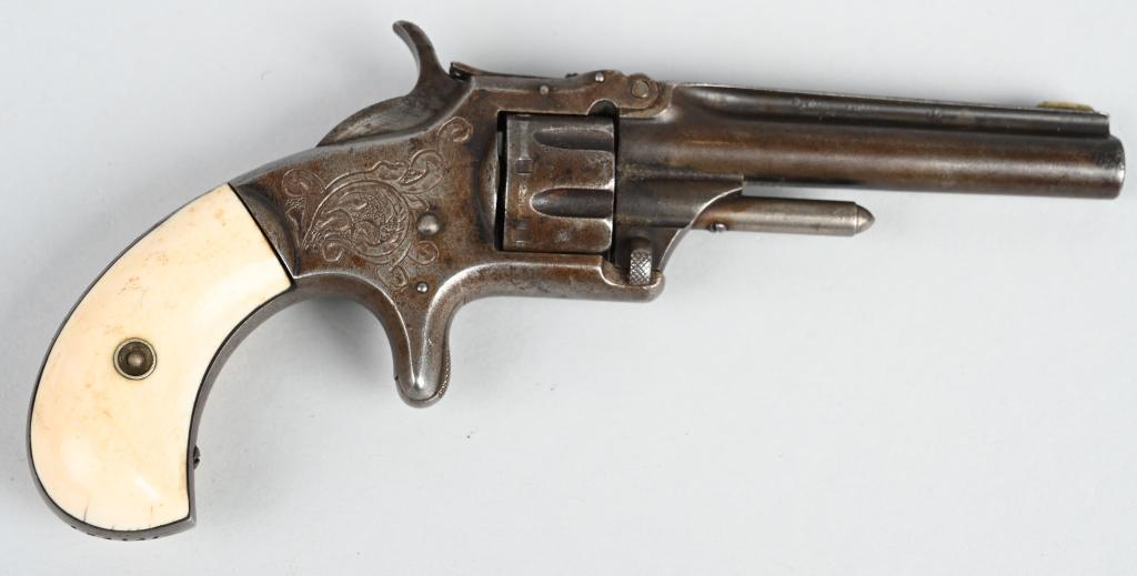FACTORY ENGRAVED S&W NO. 1 3RD ISSUE: SERIAL 104141. BARREL 3 1/4". CALIBER 22 SHORT RIMFIRE. MADE 1868-1881. Features tip up barrel, 7-shot, single action, real bone bird head grips, spur trigger engraved frame and back strap. Indexes bu
