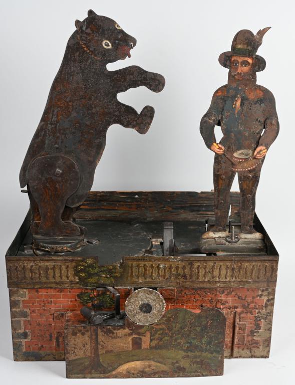INCREDIBLE 19TH CENT. MECHANICAL SHOOTING GALLERY: This rare piece is the only one we have ever seen or heard of. It is made of hand painted tin and wood and is mechanically hand crank operated. The two main targets are a bear and a drummer, each die 