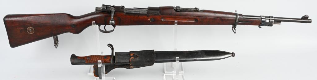 BRAZILIAN MODEL 1908 SHORT RIFLE: SERIAL 5041?. BARREL 22". CALIBER 7X57. The short rifle features the bent bolt and rear stock sling swivel. The bolt number is not matching. No import stamp. The crest is worn and metal finish is basi
