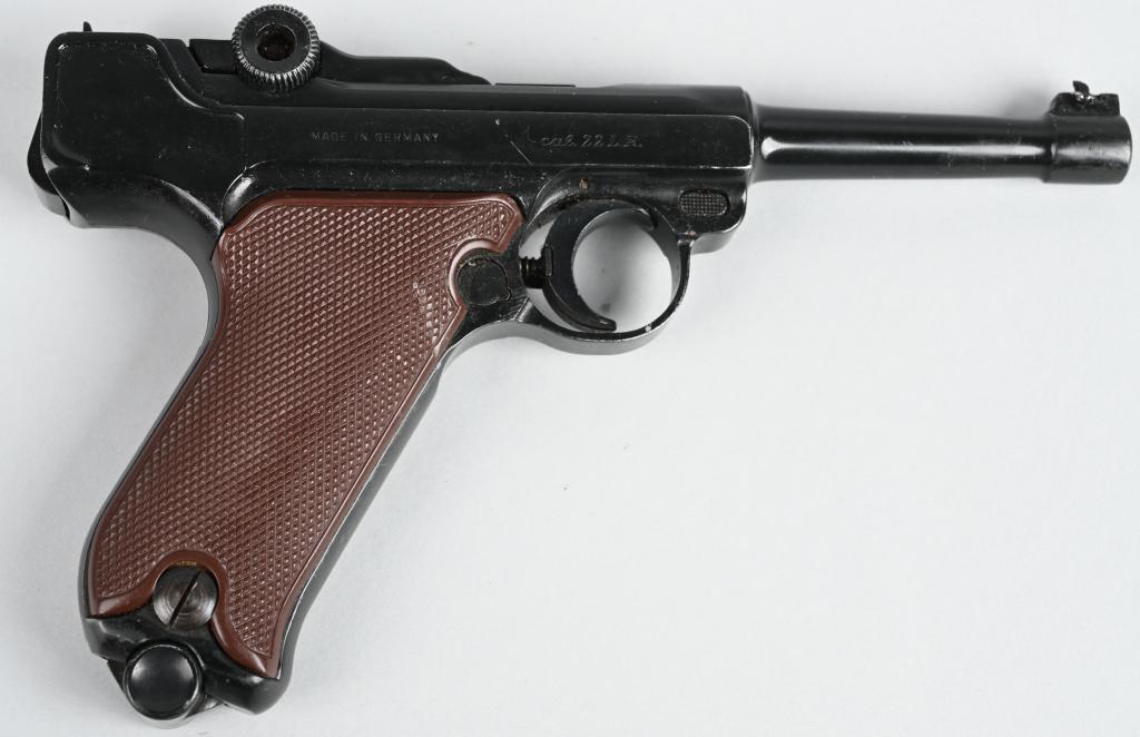 GERMAN ERMA .22 LUGER PISTOL: SERIAL 18210.. BARREL 4.5". CALIBER .22 RIMFIRE. Made in Germany, this is a quality replica of the classic Luger pistol chambered for the .22 Rimfire. Features blue finish, brown checkered plastic gri