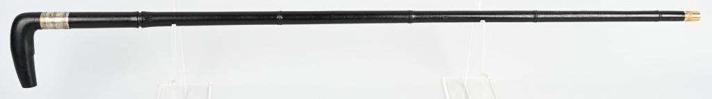UNMARKED ANTIQUE CANE GUN: Cane opens up to a 2 1/2" chamber for a cartridge shell approximately .410 with fold down trigger, black painted wood handle, black painted faux bamboo steel shaft with brass screw off cap. Has been r