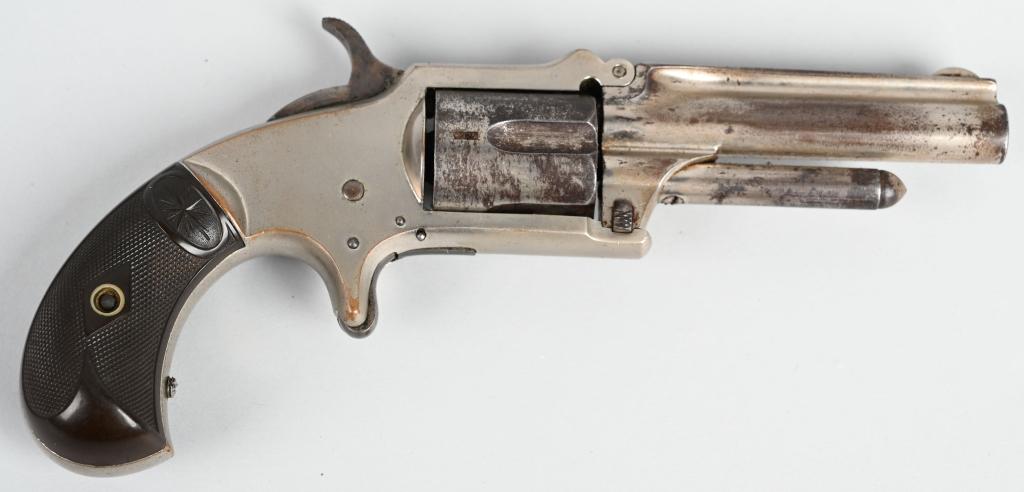 MARLIN .32 TOP HINGE POCKET REVOLVER: SERIAL NSN. BARREL 3". CALIBER .32 RIMFIRE. Features factory nickel finish, 5-shot, single action with gutta percha bird head grips. Retains 80% factory nickel with scattered age freckles. Works fine.