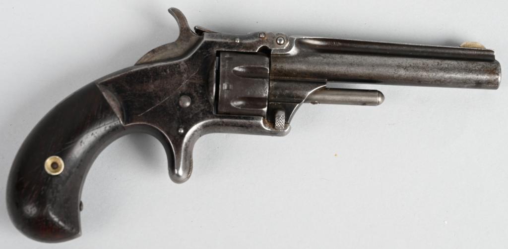 SMITH & WESSON NO. 1 1/2 SPUR TRIGGER REVOLVER: SERIAL 44116. BARREL 3.25 ". CALIBER .22 RIMFIRE. Features round barrel, 7-shot, single action with blue frame and rosewood grips. Barrel and cylinder are patina. Frame retains traces of original blue