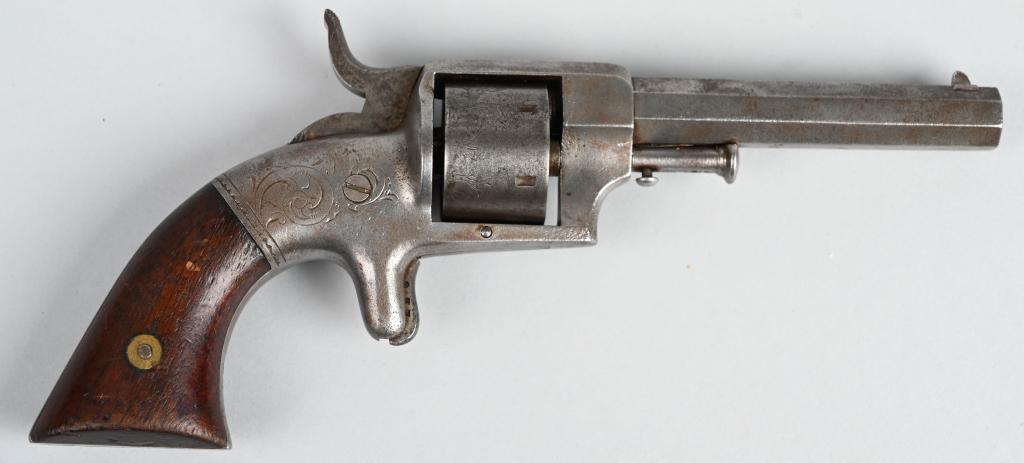 BACON SPUR TRIGGER REVOLVER: SERIAL NSN. BARREL 4". CALIBER 32 RIMFIRE. Features an octagon barrel, 6-shot, single action, spur trigger with square butt walnut grips and light engraving on frame. Metal is cleaned bright. Grips ve